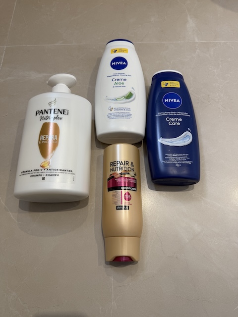 Amenities de baño con champú, gel y crema corporal listos para usar.